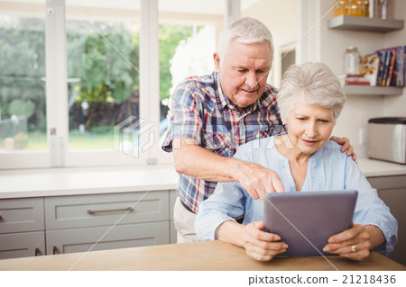 Senior couple using digital tablet Senior couple using digital tablet 21218436