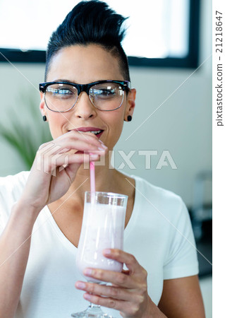 Close-up of woman drinking smoothie Close-up of woman drinking smoothie 21218647
