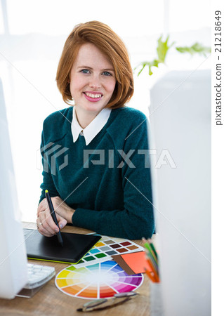 smiling hipster designer writing on a digital tablet smiling hipster designer writing on a digital tablet 21218649