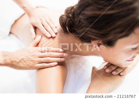 Woman receiving a back massage from masseur Woman receiving a back massage from masseur 21218767