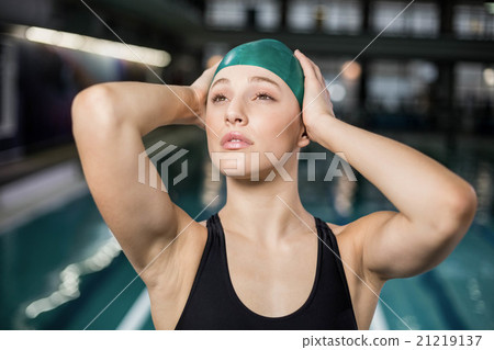 Pretty woman adjusting her bathing cap Pretty woman adjusting her bathing cap 21219137