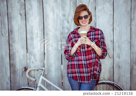 smiling hipster woman with coffee and a biycle smiling hipster woman with coffee and a biycle 21219138