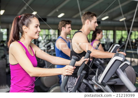 Fit people on elliptical bike 21219399