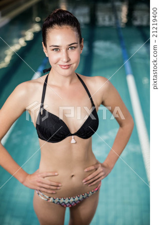 Fit woman in swimsuit with hands on hips Fit woman in swimsuit with hands on hips 21219400