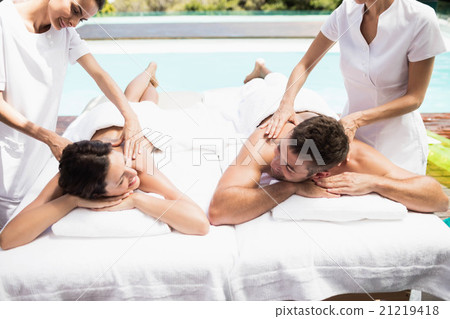 Young couple receiving a back massage from masseur Young couple receiving a back massage from masseur 21219418