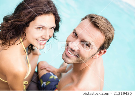 Close-up of young couple sitting by poolside Close-up of young couple sitting by poolside 21219420