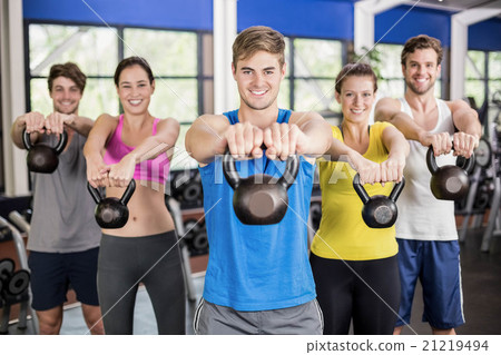 Fitness class lifting dumbbells 21219494