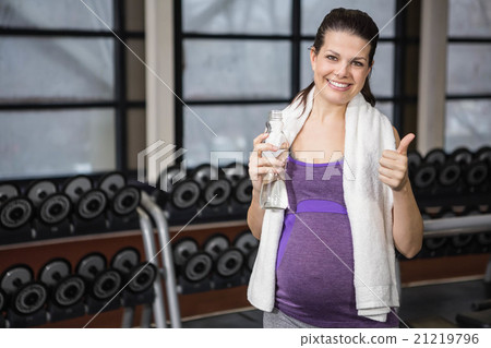 Smiling pregnant woman showing thumb up 21219796
