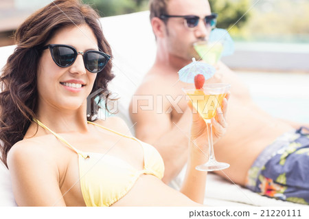 Young couple sitting on sun loungers 21220111