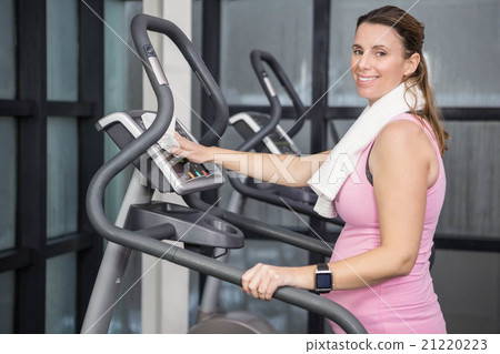 Pregnant woman on crosstrainer 21220223