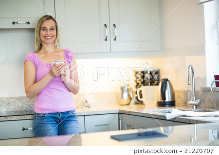 Pretty blonde woman having coffee Pretty blonde woman having coffee 21220707