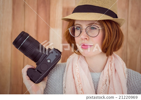 Hipster smiling and holding camera 21220969
