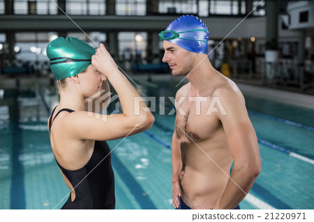 Couple in swimsuits looking at each others Couple in swimsuits looking at each others 21220971