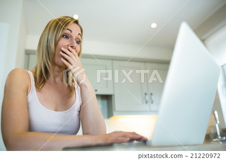Pretty blonde woman looking at laptop 21220972