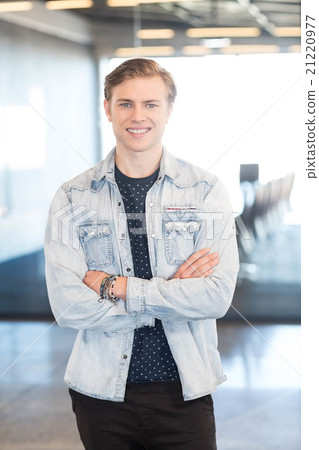 Portrait of young man in office Portrait of young man in office 21220977