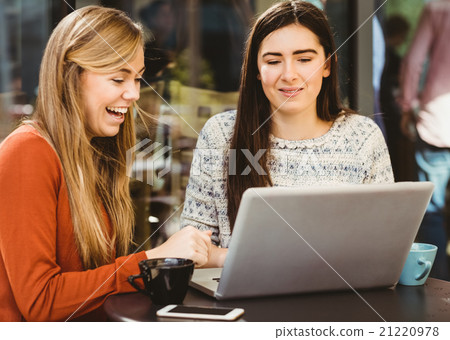 Friends using laptop together Friends using laptop together 21220978