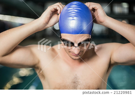 Fit man putting his goggles Fit man putting his goggles 21220981