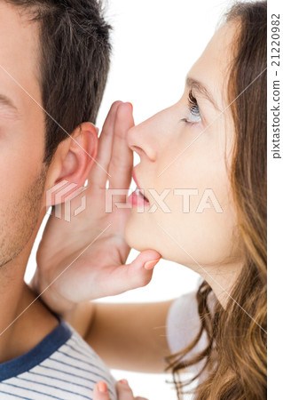 Young couple sharing a secret Young couple sharing a secret 21220982