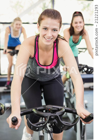 Fit group of people using exercise bike together Fit group of people using exercise bike together 21221293