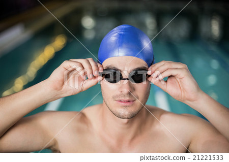 Fit man adjusting his goggles Fit man adjusting his goggles 21221533
