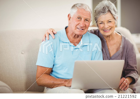 Senior couple sitting on sofa Senior couple sitting on sofa 21221592