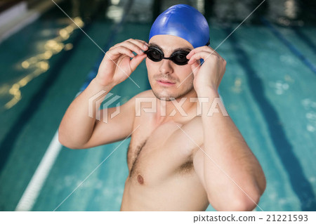 Fit man adjusting his goggles Fit man adjusting his goggles 21221593