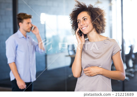 Colleagues communicating on mobile phone Colleagues communicating on mobile phone 21221689
