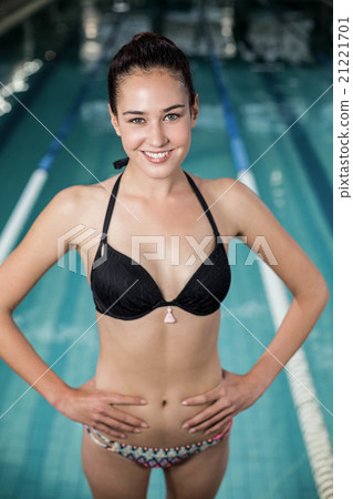 Fit woman in swimsuit with hands on hips 21221701