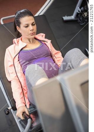 Pregnant woman using weight machine Pregnant woman using weight machine 21221765