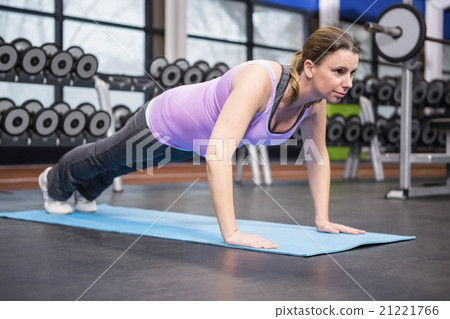 Determined woman doing push up Determined woman doing push up 21221766