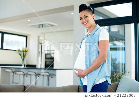 Portrait of pregnant woman touching her belly 21222005