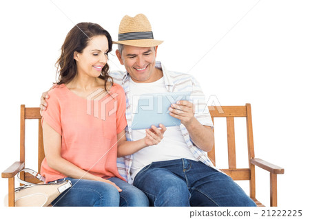 Couple on bench using tablet 21222225