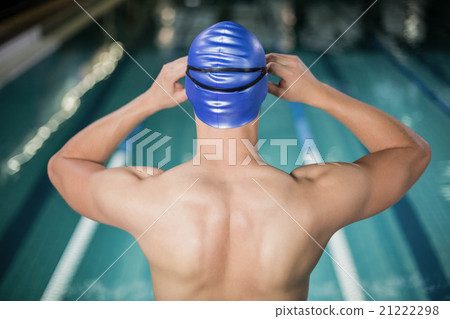 Fit man adjusting his goggles Fit man adjusting his goggles 21222298