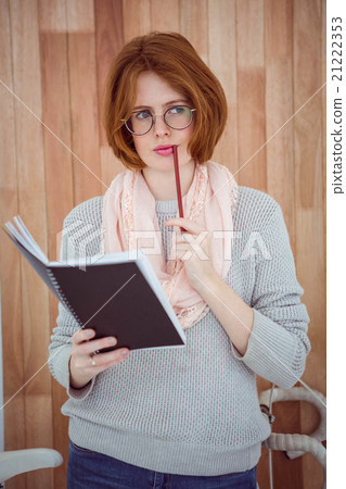 pensive hipster woman with a notepad and pencil pensive hipster woman with a notepad and pencil 21222353