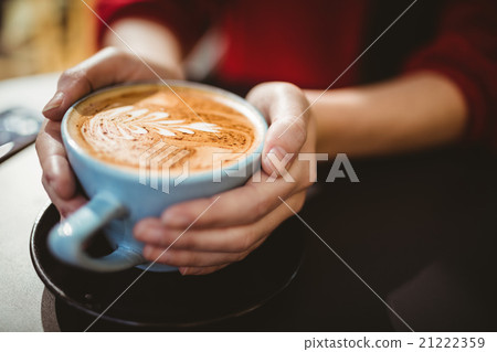 Woman holding a cup of coffee Woman holding a cup of coffee 21222359