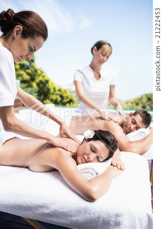 Young couple receiving a back massage from masseur Young couple receiving a back massage from masseur 21222453