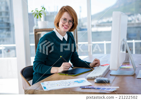 smiling hipster designer writing on a digital tablet smiling hipster designer writing on a digital tablet 21222502