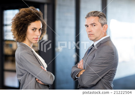 Businessman and businesswoman with arms crossed Businessman and businesswoman with arms crossed 21222504
