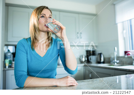 Pretty blonde woman drinking a glass of water 21222547
