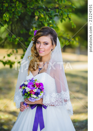 The girl in a wedding dress with purple bow 21224591