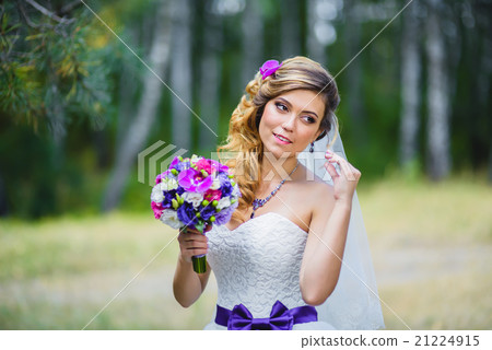 The girl in a wedding dress with purple bow The girl in a wedding dress with purple bow 21224915