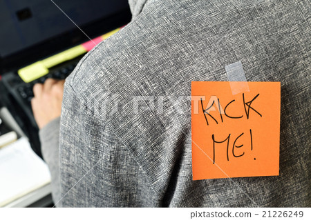 man with a paper with the text kick me in his back 21226249