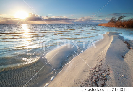 sunshine over big Ijsselmeer lake coast sunshine over big Ijsselmeer lake coast 21230161