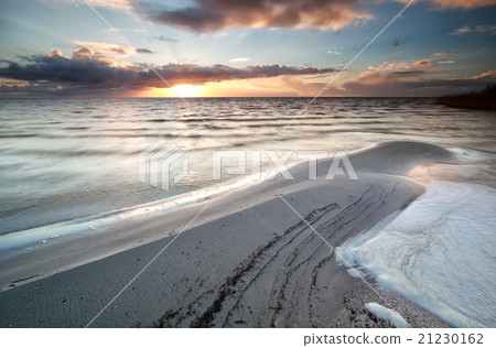 sundown during low tide on Ijsselmeer lake sundown during low tide on Ijsselmeer lake 21230162