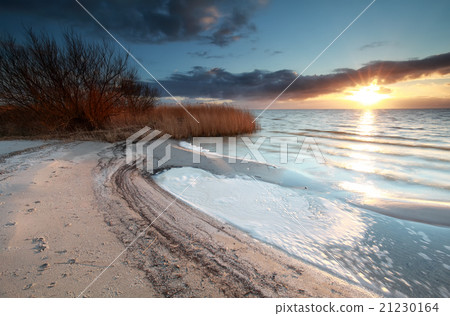 sunshine over beach on lake Ijsselmeer sunshine over beach on lake Ijsselmeer 21230164