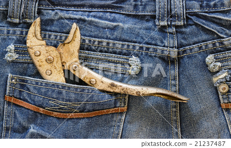 Wrench locked in a blue jeans pocket. Wrench locked in a blue jeans pocket. 21237487