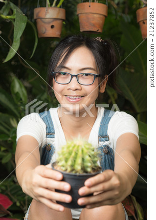 Woman holding a cactus Woman holding a cactus 21237852