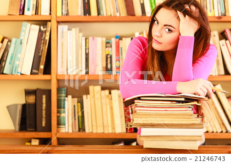 Tired girl student in college library Tired girl student in college library 21246743