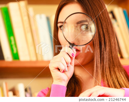 Girl holding magnifying glass Girl holding magnifying glass 21246744