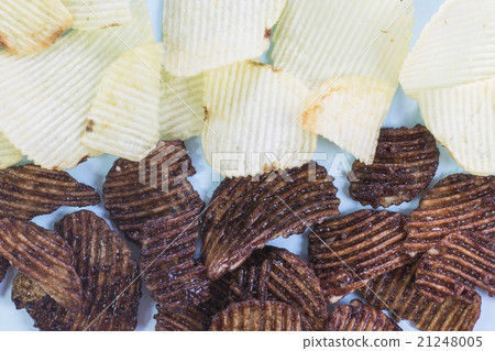 Chocalate and salt potato chips on blue background 21248005
